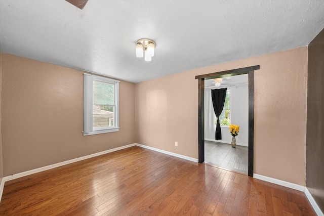 spare room featuring hardwood / wood-style floors and a healthy amount of sunlight