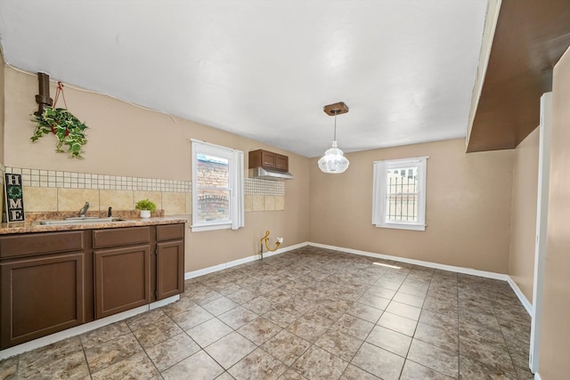 unfurnished dining area featuring sink