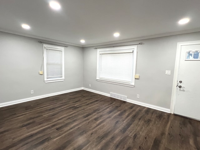 foyer featuring dark wood-type flooring and crown molding