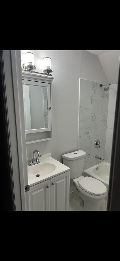 full bath featuring  shower combination, toilet, and vanity
