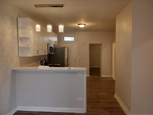 kitchen with light countertops, open shelves, white cabinetry, a peninsula, and stainless steel appliances