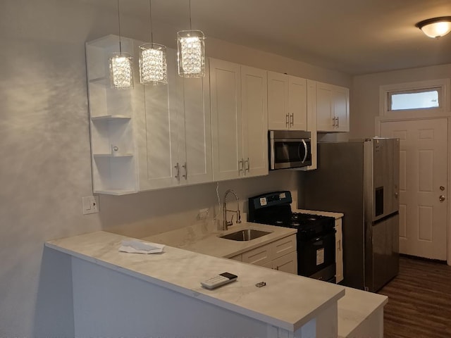 kitchen featuring white cabinetry, light countertops, a sink, and appliances with stainless steel finishes