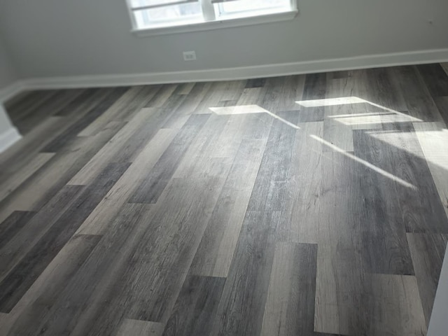room details with baseboards and wood finished floors