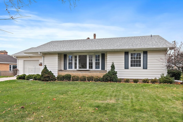 ranch-style house featuring a garage and a front lawn