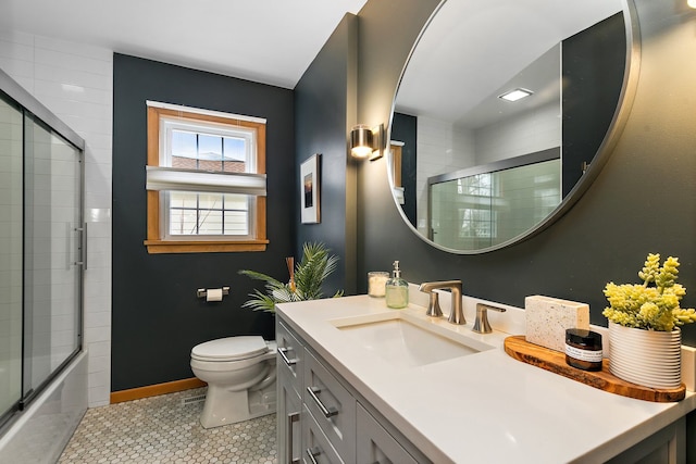 full bathroom featuring tile patterned flooring, vanity, bath / shower combo with glass door, and toilet