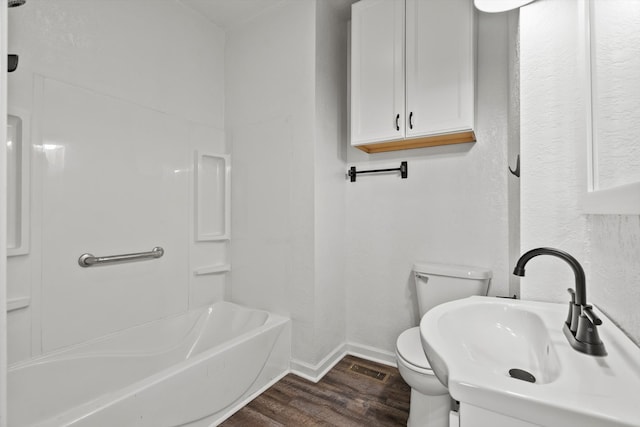 full bathroom featuring toilet, sink, washtub / shower combination, and hardwood / wood-style floors