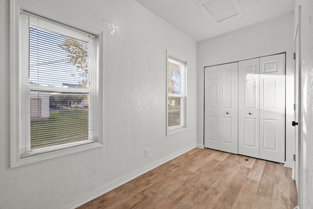 unfurnished bedroom featuring light hardwood / wood-style flooring and a closet