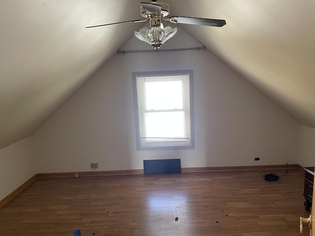 additional living space with dark hardwood / wood-style floors, ceiling fan, and lofted ceiling