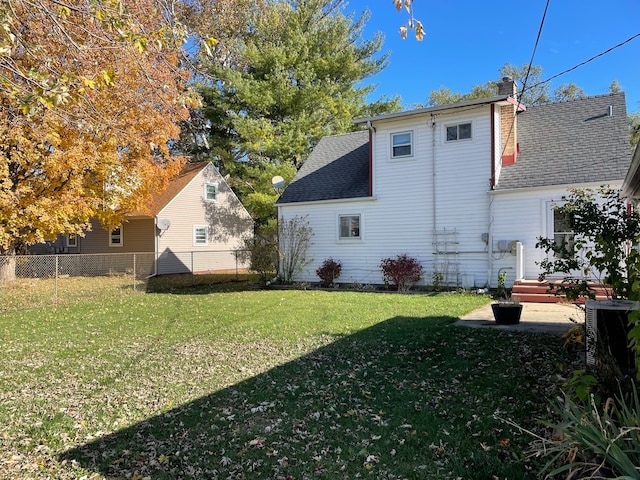 back of property with a lawn