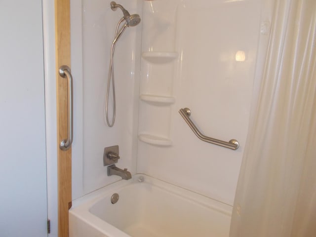 bathroom with shower / tub combo with curtain