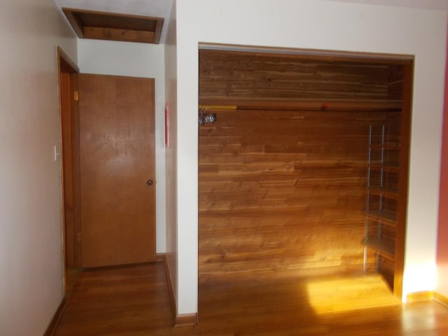 hallway with dark hardwood / wood-style floors