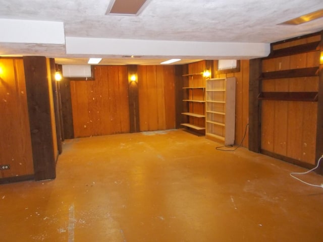 basement featuring wood walls