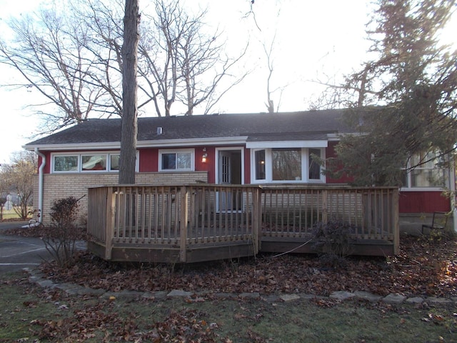 rear view of house featuring a wooden deck