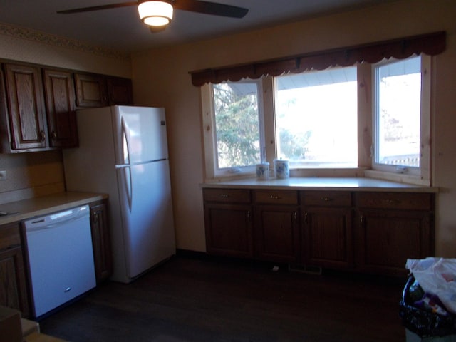 kitchen with dark hardwood / wood-style floors, ceiling fan, and white appliances