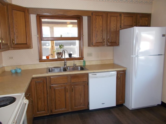 kitchen with decorative backsplash, white appliances, sink, and dark wood-type flooring