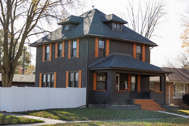 view of front of home with a front yard and a porch