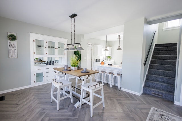 dining area with dark parquet flooring