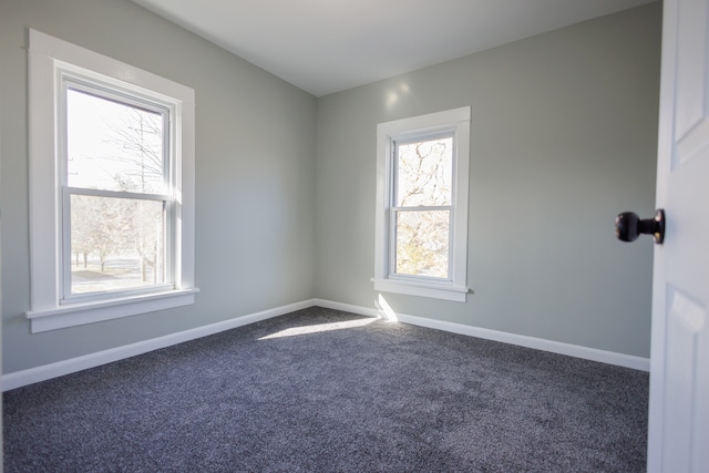 empty room featuring dark carpet