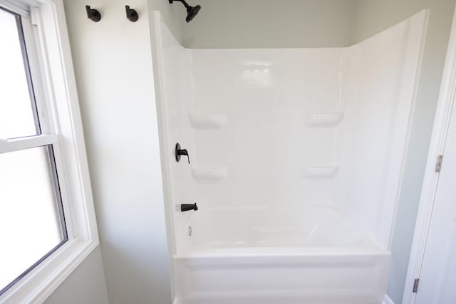 bathroom featuring  shower combination and plenty of natural light