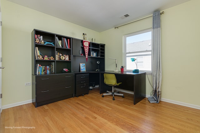 office area with light hardwood / wood-style floors