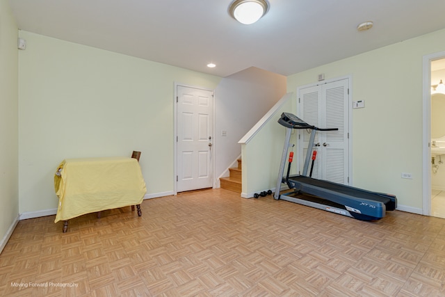 workout room featuring light parquet flooring