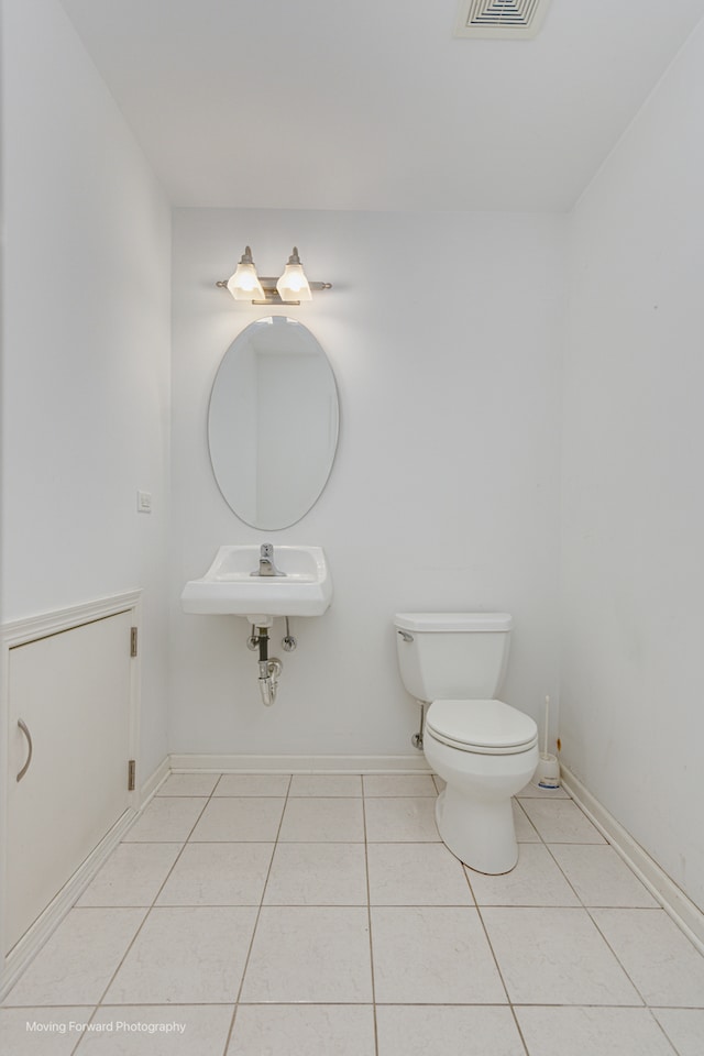 bathroom with tile patterned flooring, sink, and toilet