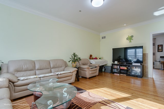 living room featuring ornamental molding and light hardwood / wood-style floors