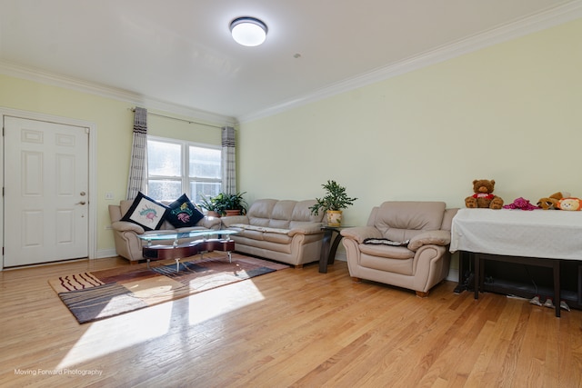 living room with ornamental molding and light hardwood / wood-style flooring