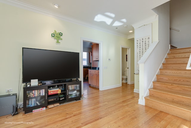 living room featuring wood-type flooring and ornamental molding