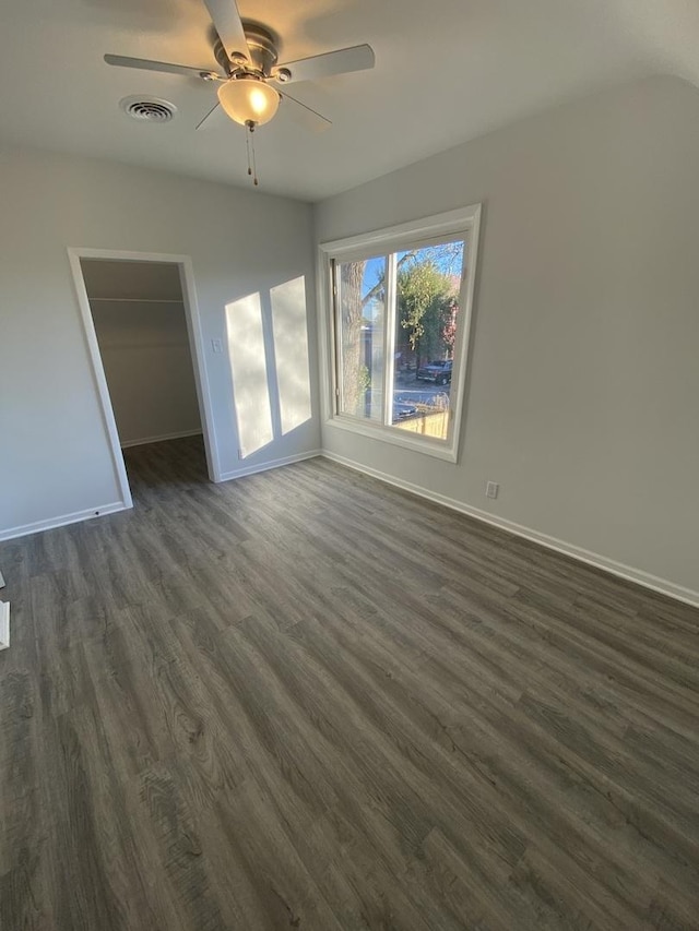 unfurnished room featuring ceiling fan and dark hardwood / wood-style floors