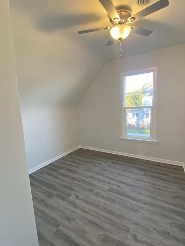 additional living space with lofted ceiling, ceiling fan, and dark wood-type flooring