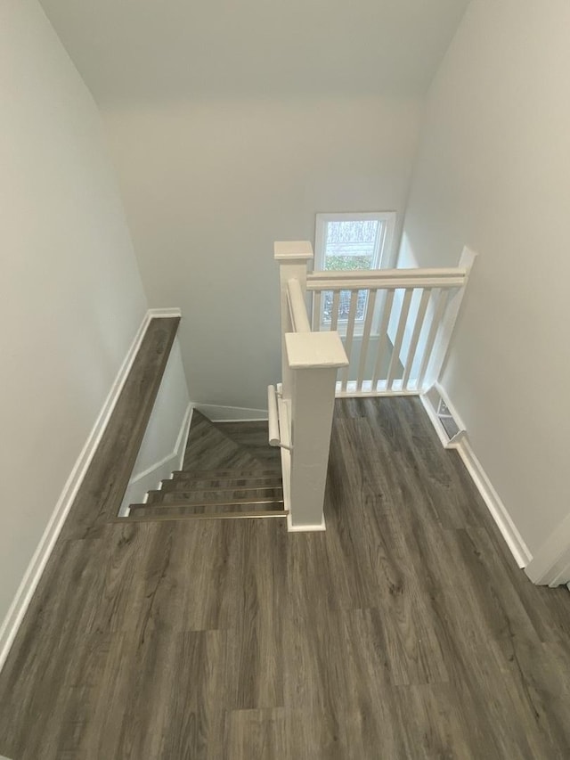 stairway with hardwood / wood-style flooring