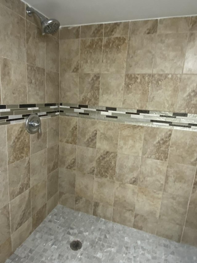 bathroom with a tile shower