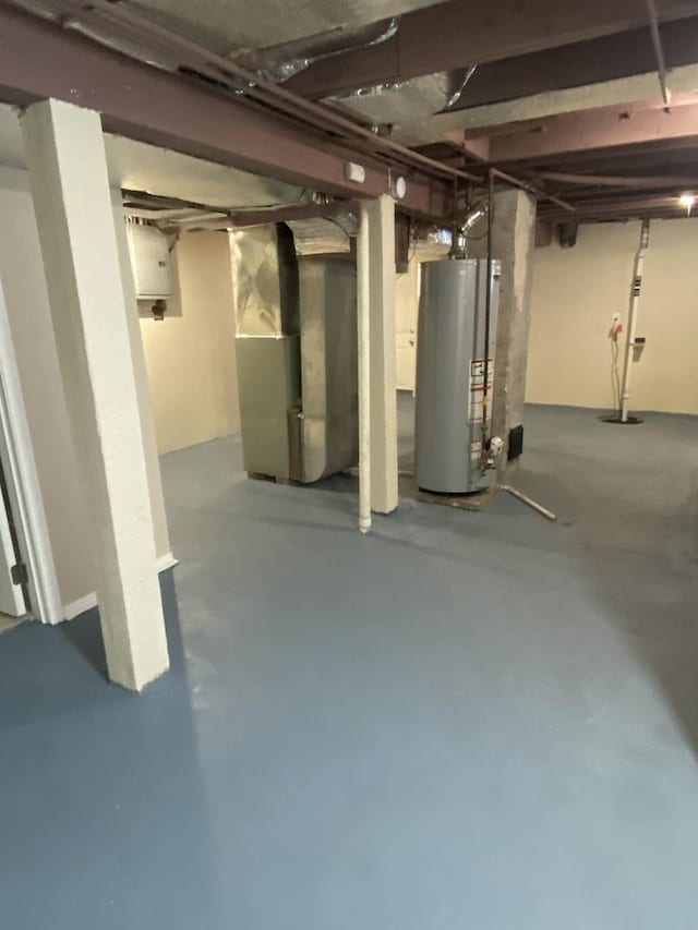 basement featuring heating unit and water heater