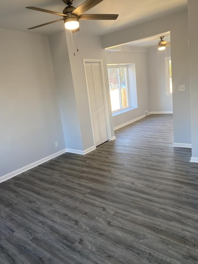 unfurnished room featuring ceiling fan and dark hardwood / wood-style floors