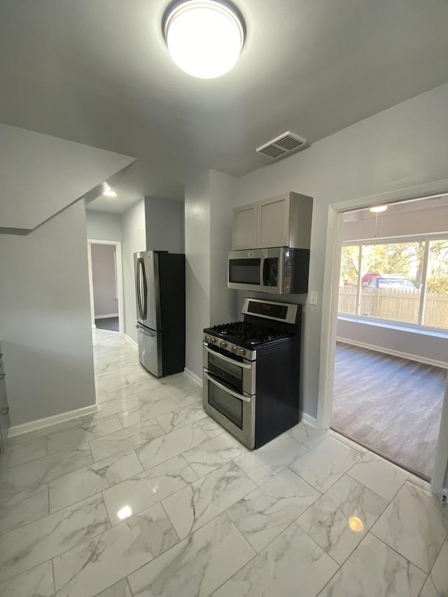 kitchen featuring appliances with stainless steel finishes and gray cabinets