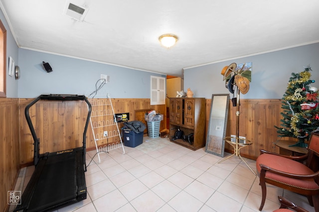 exercise area with wooden walls and crown molding