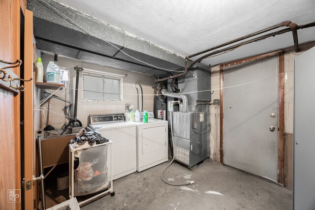 basement with heating unit and washing machine and clothes dryer