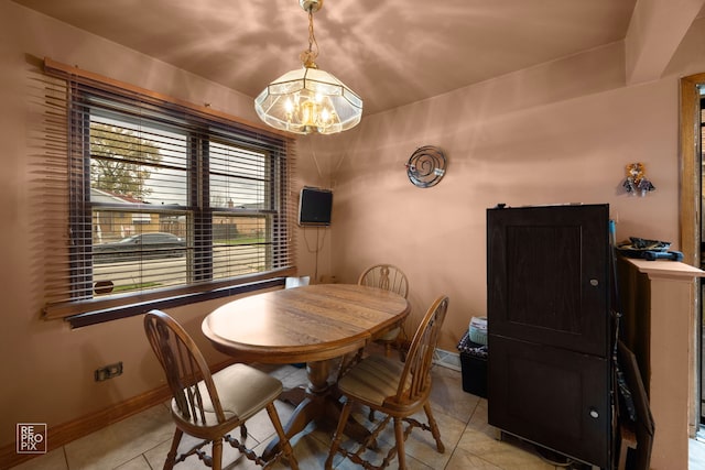 dining space with a wealth of natural light, a chandelier, and light tile patterned flooring