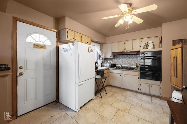 kitchen with black appliances, cream cabinets, ceiling fan, light tile patterned floors, and backsplash