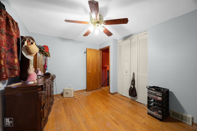 miscellaneous room featuring ceiling fan and light hardwood / wood-style flooring