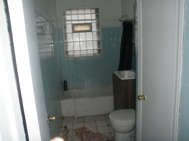 bathroom featuring toilet, shower / tub combo, and tile patterned flooring