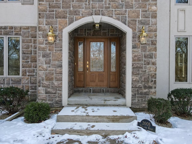 view of snow covered property entrance