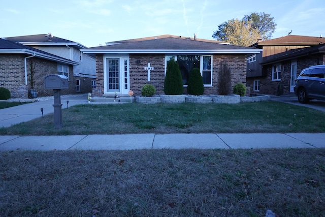 ranch-style home with a front lawn