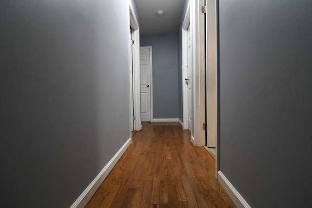 corridor with hardwood / wood-style floors