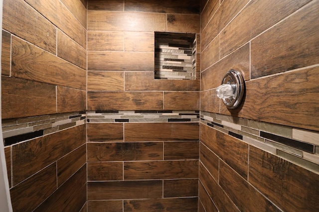 bathroom featuring wood walls and a shower