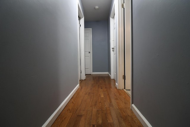 corridor with wood-type flooring