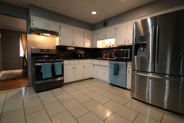 kitchen featuring backsplash, white cabinets, and appliances with stainless steel finishes