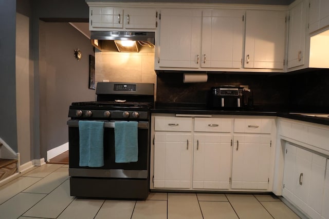 kitchen with white cabinetry, decorative backsplash, stainless steel gas stove, and exhaust hood