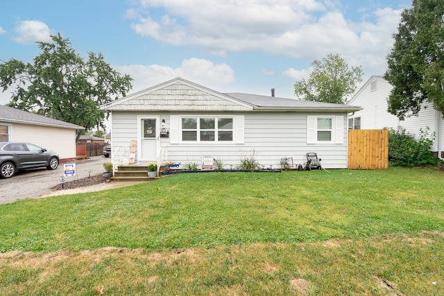 ranch-style home with a front lawn